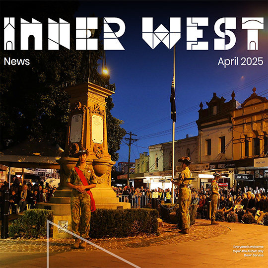 A commemorative dawn service taking place at a cenotaph in a town square.